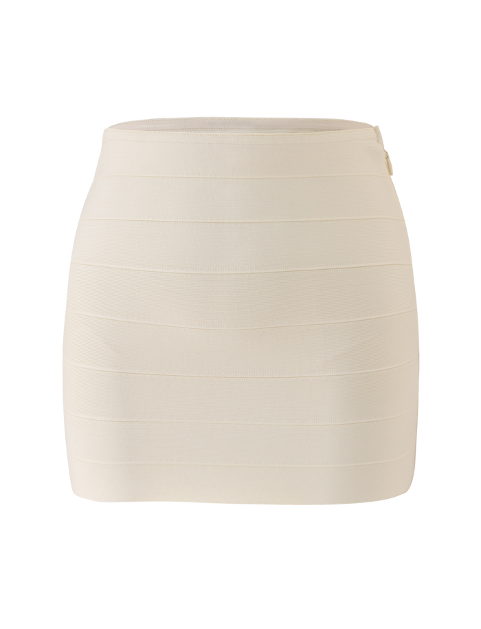 The NYX BANDAGE MINI SKIRT by TIGERMIST is a fitted, high-waisted cream mini skirt featuring horizontal panel details and a side zipper, shown against a plain white background.