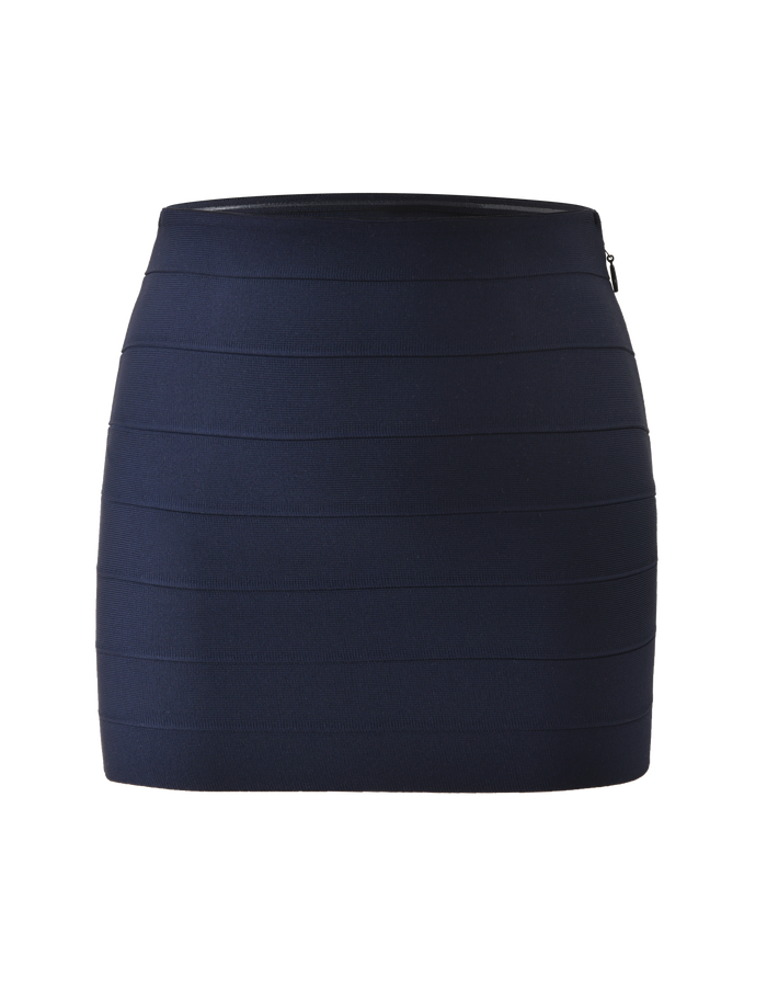 The NYX Bandage Mini Skirt by TIGERMIST is a navy blue, high-waisted mini skirt with horizontal seam detailing, shown on a plain white background.