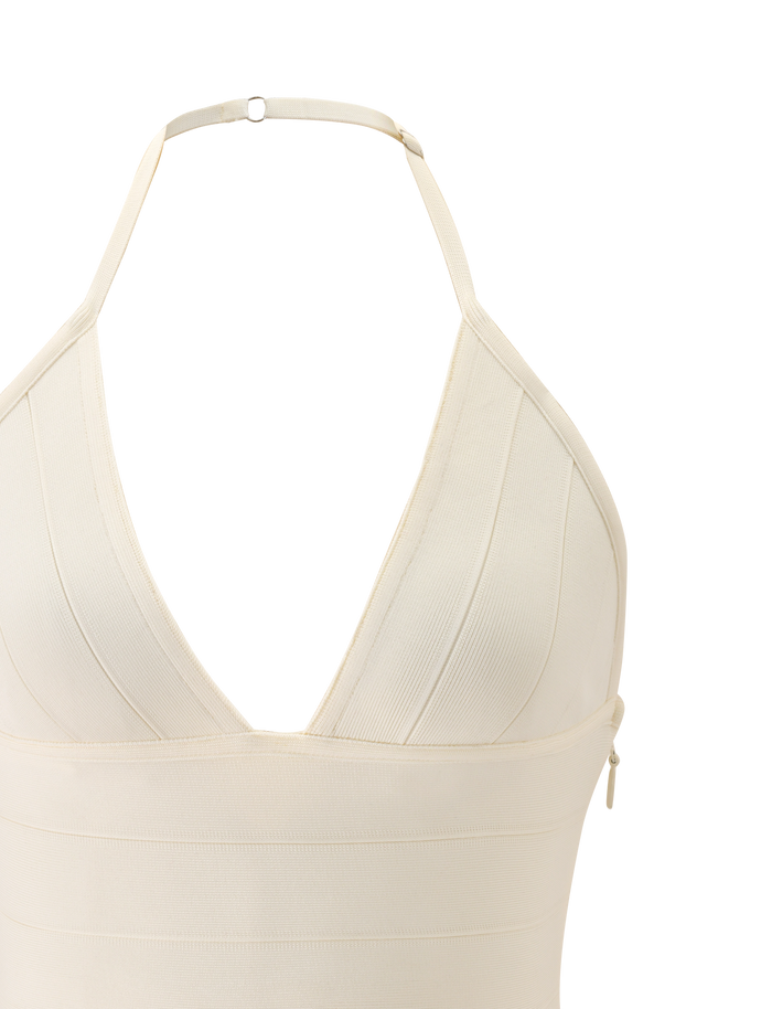 Close-up of the TIGERMIST NYX BANDAGE TOP in cream, featuring a halter neck, plunging triangle cups, visible stitching, adjustable neck strap with metal clasp, and thick structured fabric for a sculpted fit.