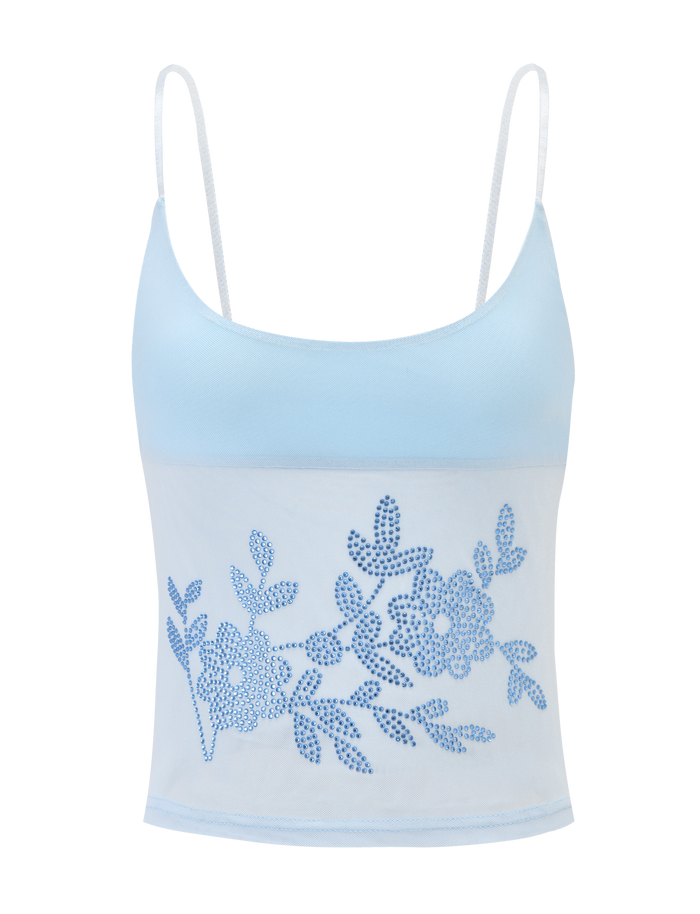 The OCTAVIA TOP - BABY BLUE by TIGERMIST is a baby blue spaghetti strap crop top with a sheer mesh bottom panel and an elegant blue floral embellishment on the front.