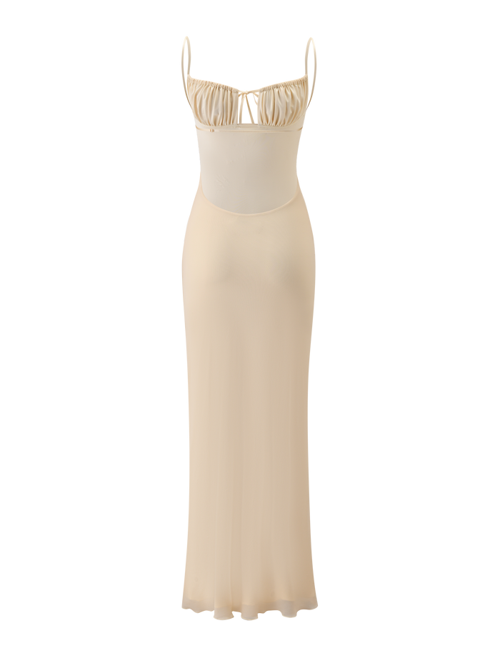 The OPHELIA MAXI DRESS - CREAM by TIGERMIST features adjustable spaghetti straps, a ruched bust, and a fitted silhouette. This semi-sheer, minimalist design delivers effortless elegance for any occasion.