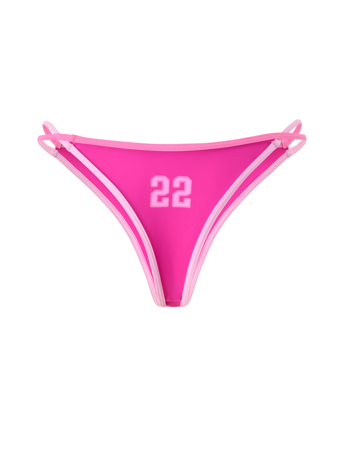 The PALMER BIKINI BOTTOM - BERRY by TIGERMIST is a bright pink bikini bottom with white trim, double side straps, and a sporty white "22" print on the front. Features a cheeky fit and is great for bold summer looks.