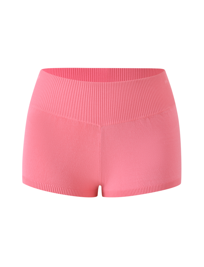 The PARKER KNIT MICRO SHORT - CORAL by TIGERMIST features a bright pink hue with a seamless, high-waisted bodycon fit. These fine knit shorts are designed with ribbed waist and leg bands and are displayed from the front against a plain white background.