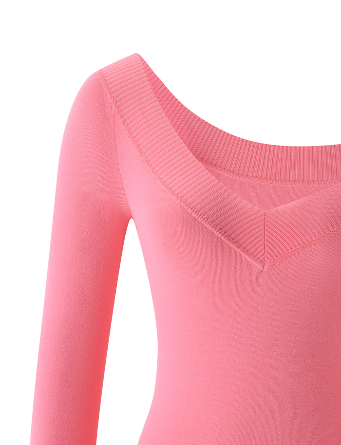 Close-up of the TIGERMIST PARKER KNIT TOP in coral, showcasing its long sleeves and wide V-neck with ribbed detailing on the neckline, displayed against a plain white background.