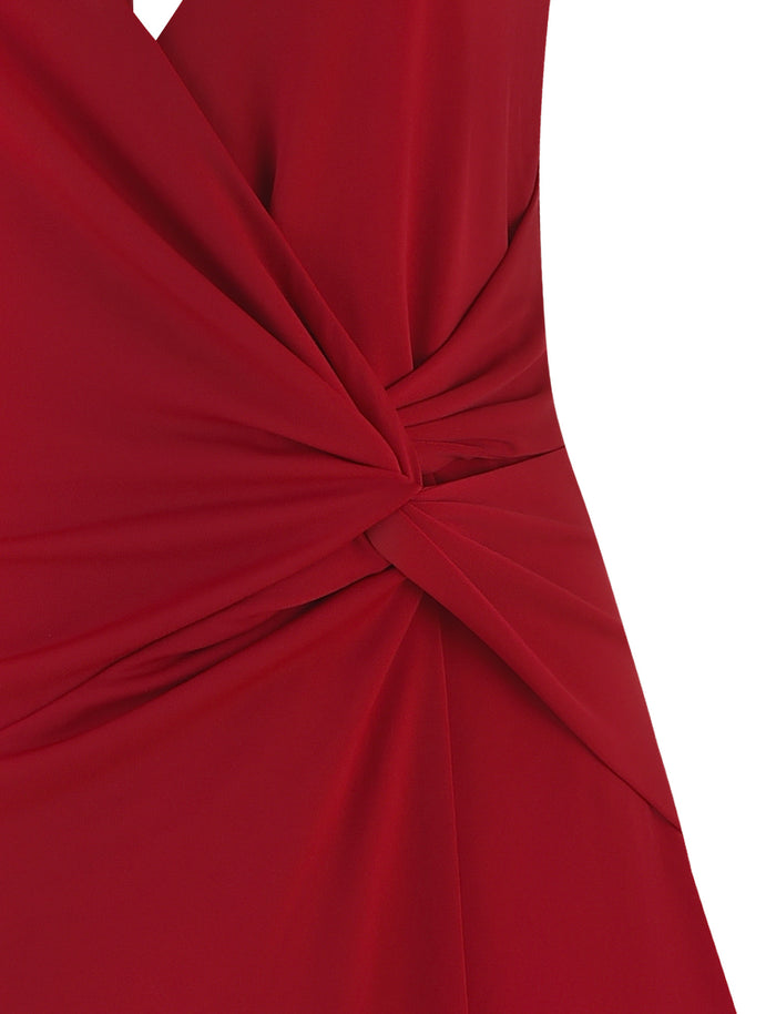 Close-up of the PARRIS DRESS - RED by TIGERMIST, a red halter neck dress featuring intricate twist detailing at the waist that creates a gathered and draped effect in the fabric. The material has a smooth, matte finish, adding elegance and sophistication to this chic mini dress.