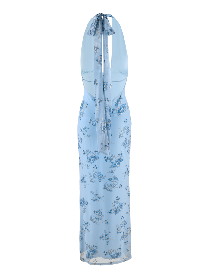 The PHAEDRA MAXI DRESS by TIGERMIST features a light blue floral print, halter neck with long ribbon tie, sleeveless and backless design, with the ribbon draping down the open back.