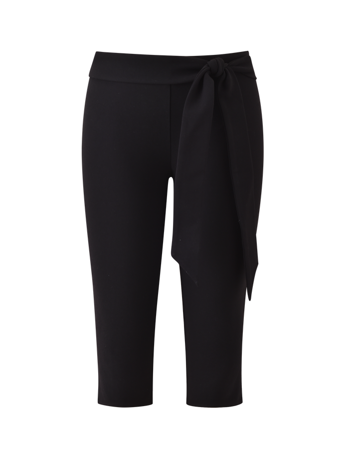 The TIGERMIST PILAR CAPRI - BLACK is a black ponte capri pant with a mid rise waist and a wide, removable tie knotted on the left, shown against a plain white backdrop.
