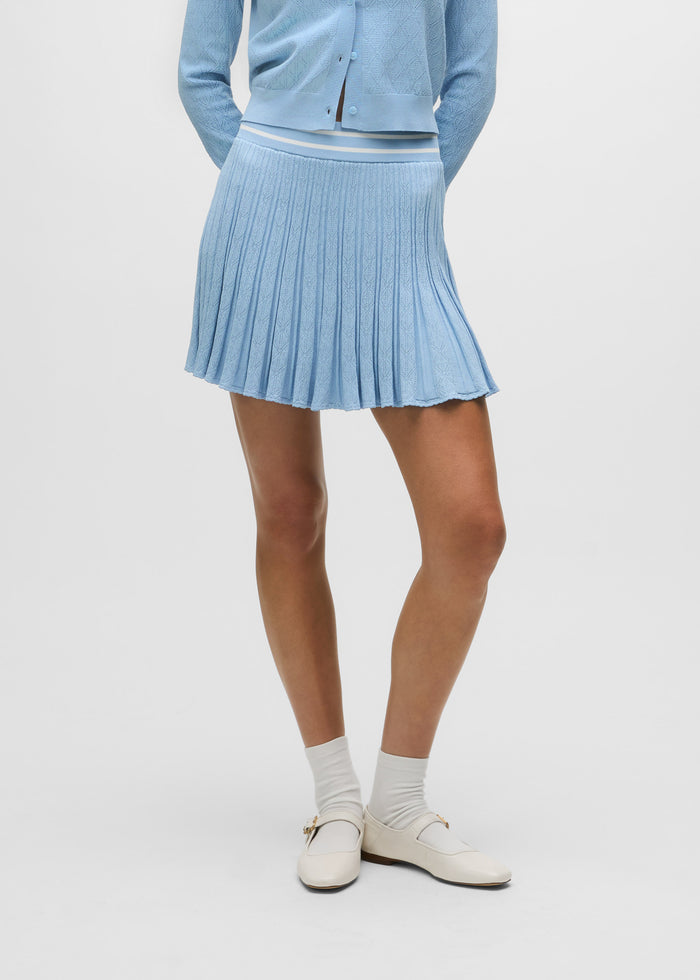 Maltese Blue Pointelle Skirt - Front View, Pleated Knit with Stripe Waistband, On Model | Greyson Clothiers