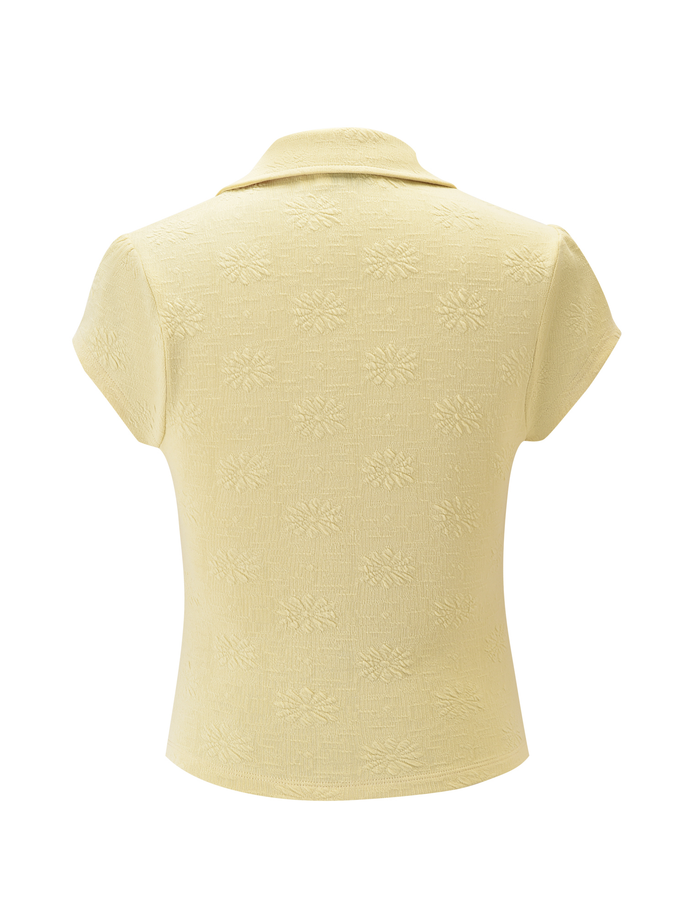Back view of the TIGERMIST QUINLAN TOP in lemon—a short-sleeved, stretchy top with a collar and a subtle floral textured pattern.