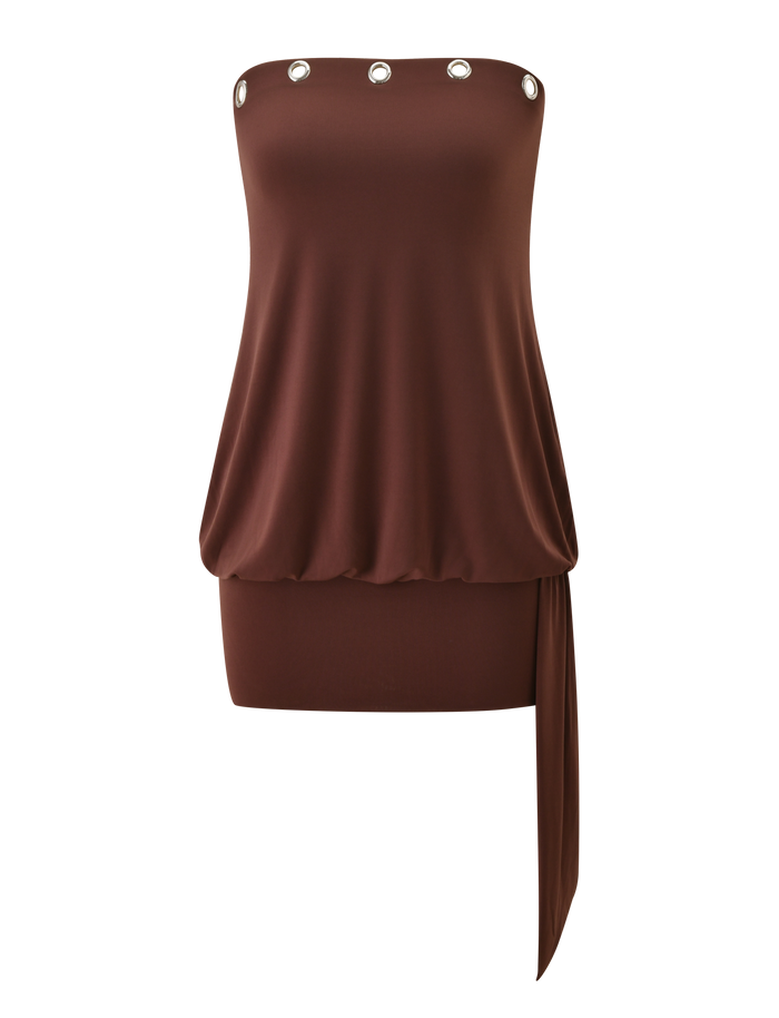 The RAVENNA DRESS - MILK CHOCOLATE by TIGERMIST is a strapless mini dress with a loose draped top, silver eyelet trim at the neckline, an asymmetrical sash, and a bodycon drop waist mini skirt.