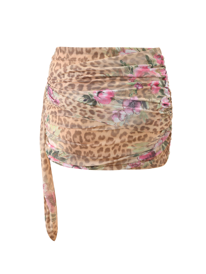 The RISA MINI SKIRT - LEOPARD FLORAL by TIGERMIST features a ruched leopard print with pink floral accents and a draped side tie, shown against a plain white background.