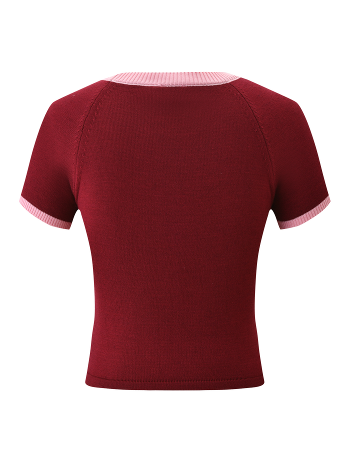 The ROUX TOP - RED by TIGERMIST is a short-sleeved, fitted knit top in red, featuring pink accent details and light pink ribbed trim on the collar and sleeve cuffs.
