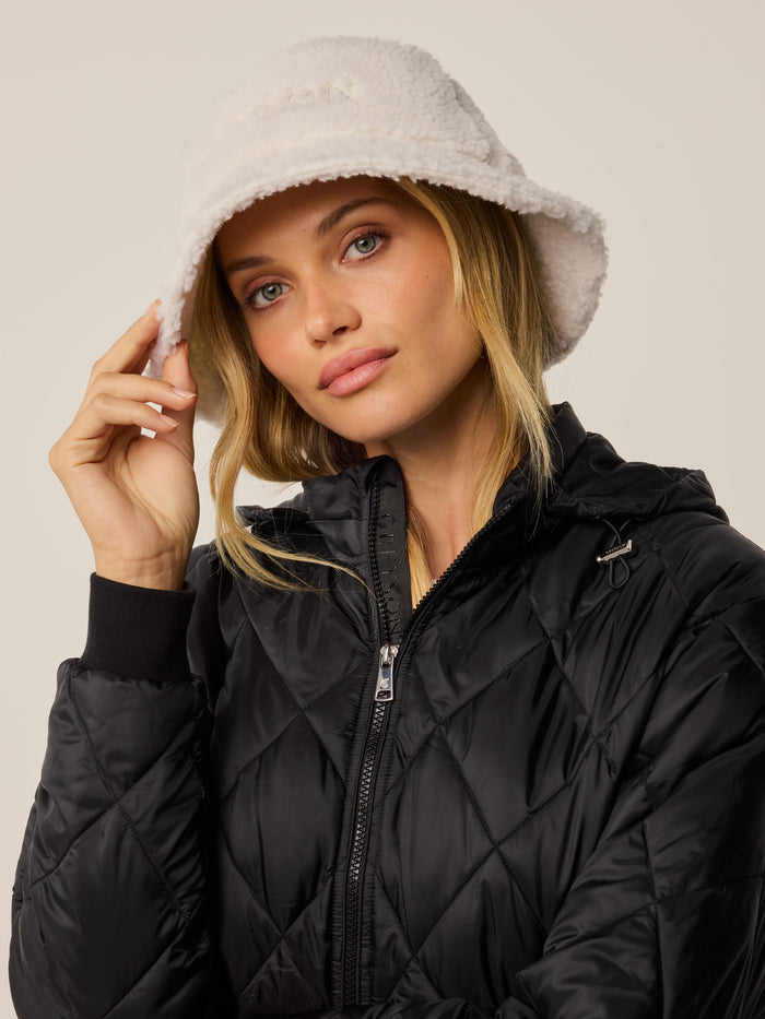 Dove Sherpa Bucket Hat On Model with Black Quilted Jacket - Women's Sherpa Bucket Hat | Greyson Clothiers