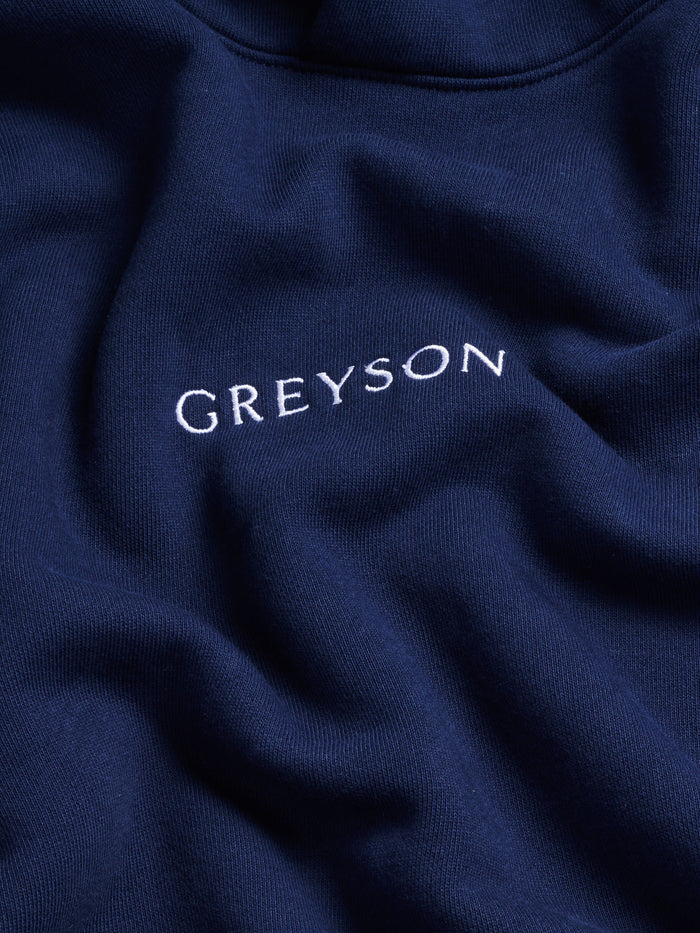 Greyson Script Logo Embroidery Close-Up on Maltese Blue Cotton Hoodie | Greyson Clothiers