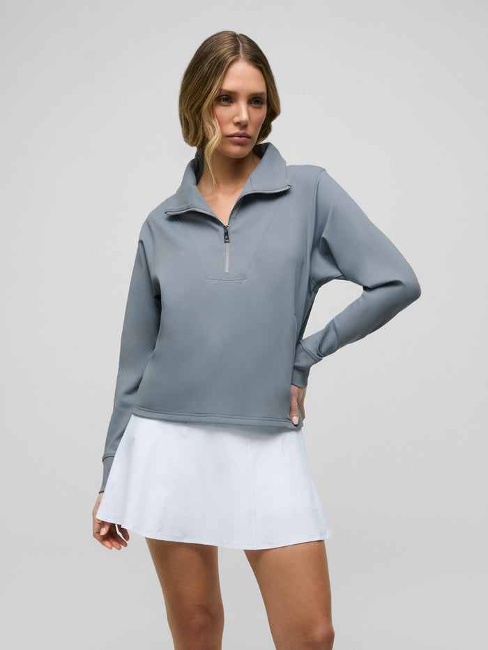 Bluestone Soleil Half Zip Pullover - Front View, Women's Golf Layer Styled with White Skirt | Greyson Clothiers