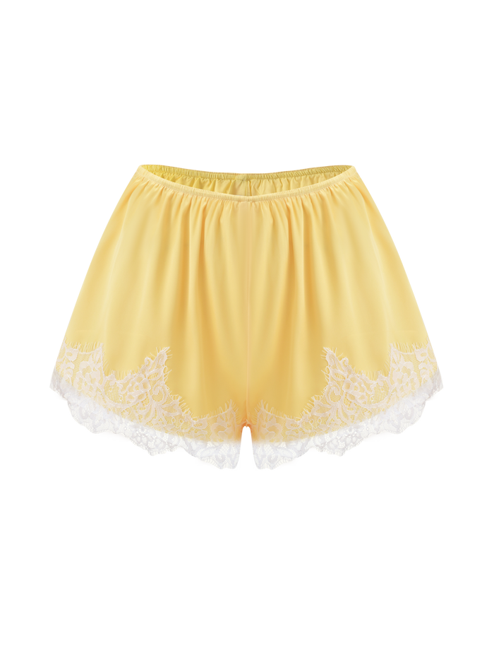The TIGERMIST SOLSTICE SHORT in yellow is a satin mini short featuring an elastic waistband and delicate white lace trim along the hem, shown against a plain white background.