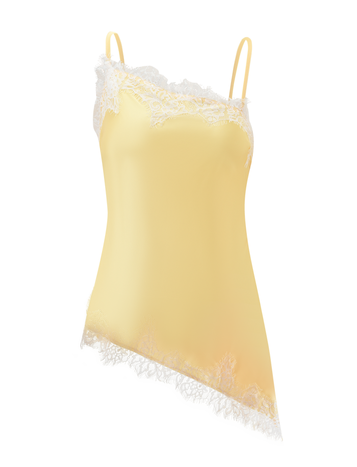 The SOLSTICE TOP - YELLOW by TIGERMIST is a yellow singlet with thin straps, white lace trim on the top edge and asymmetrical hem, shown on a white background.