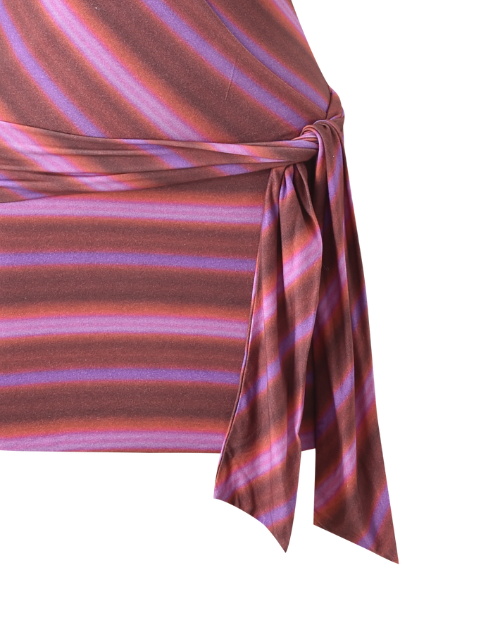 Close-up of the SORRENTO MINI DRESS - DUSK OMBRE STRIPE by TIGERMIST, featuring diagonal pink, purple, and brown stripes with a faux wrap silhouette and side tied knot detail.