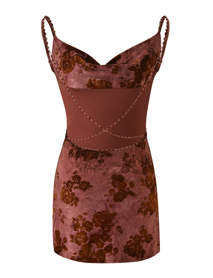 The TIGERMIST SPARROW MINI DRESS - CHOCOLATE BURNOUT is a sleeveless, fitted mini dress in mauve and brown floral print. It features thin straps, a cowl neckline, and decorative crisscross torso detailing.