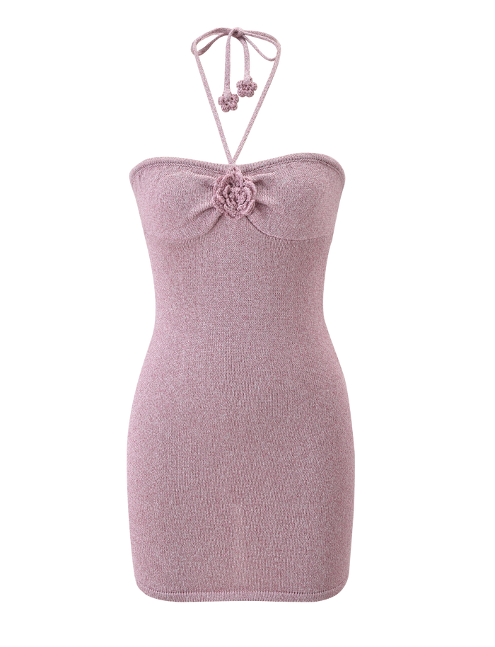 The SUNIA DRESS - BABY PINK by TIGERMIST is a light pink, strapless bodycon mini with a halter neck tie, center chest flower detail, and soft fabric with a subtle metallic sheen displayed on a plain white background.