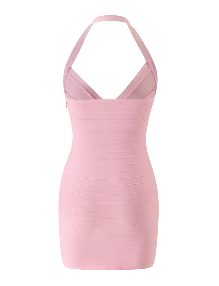 The SYDEL BANDAGE MINI DRESS in Pink Peony by TIGERMIST is a light pink, form-fitting halter mini dress with horizontal bandage-style lines, a V-shaped neckline, and an open back. This sleeveless dress ends above the knees and is photographed against a white background.