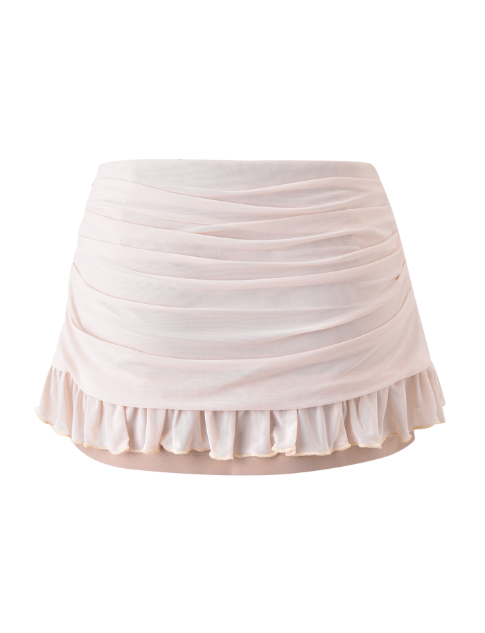 The TERESE FLORAL APPLIQUE SKIRT by TIGERMIST is a tan, short ballet wrap skirt with soft sheer fabric, ruched draping reminiscent of a mini skirt, and a ruffled hemline, displayed against a plain white background.