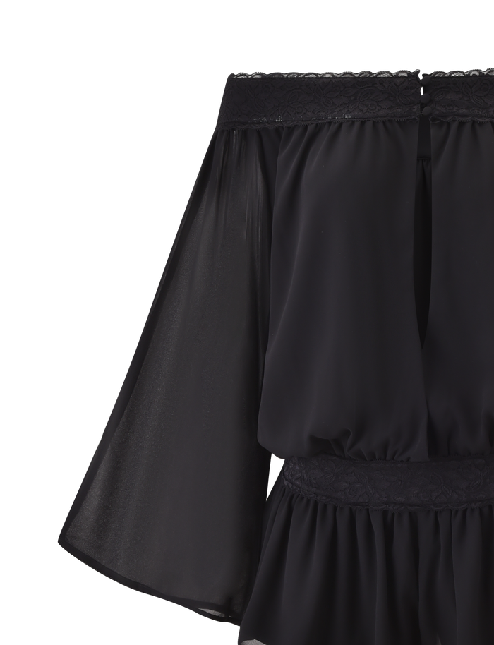A close-up of the TIGERMIST TESSIE PLAYSUIT in black, featuring sheer, flowy off-shoulder sleeves and delicate lace trim on the neckline and waist, set against a crisp white background.