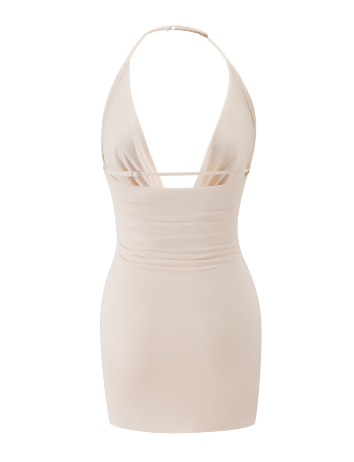 The THARA MINI DRESS - CREAM by TIGERMIST is a fitted cream mini with an adjustable halter neck, thin straps, deep V-cut front, ruched waist, and a sleek minimalist style for an effortlessly chic look.