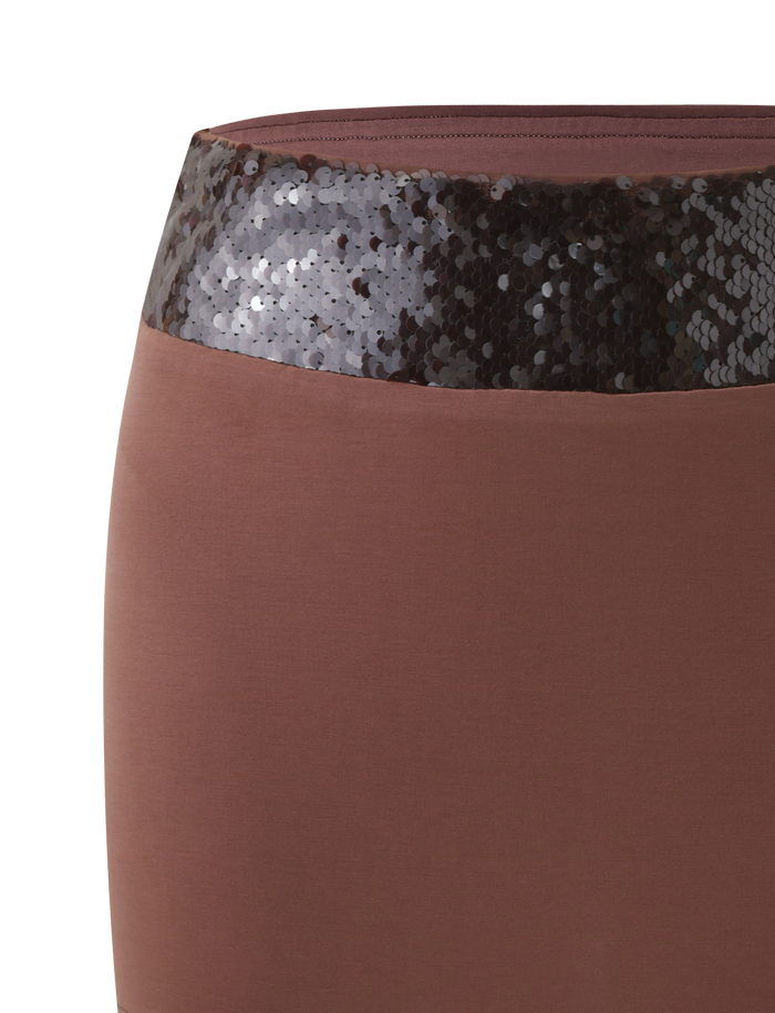 Close-up of the TIGERMIST THARA MINI SKIRT in chocolate, showcasing a wide sequin waistband that adds a textured, contrasting accent for a chic mini silhouette.