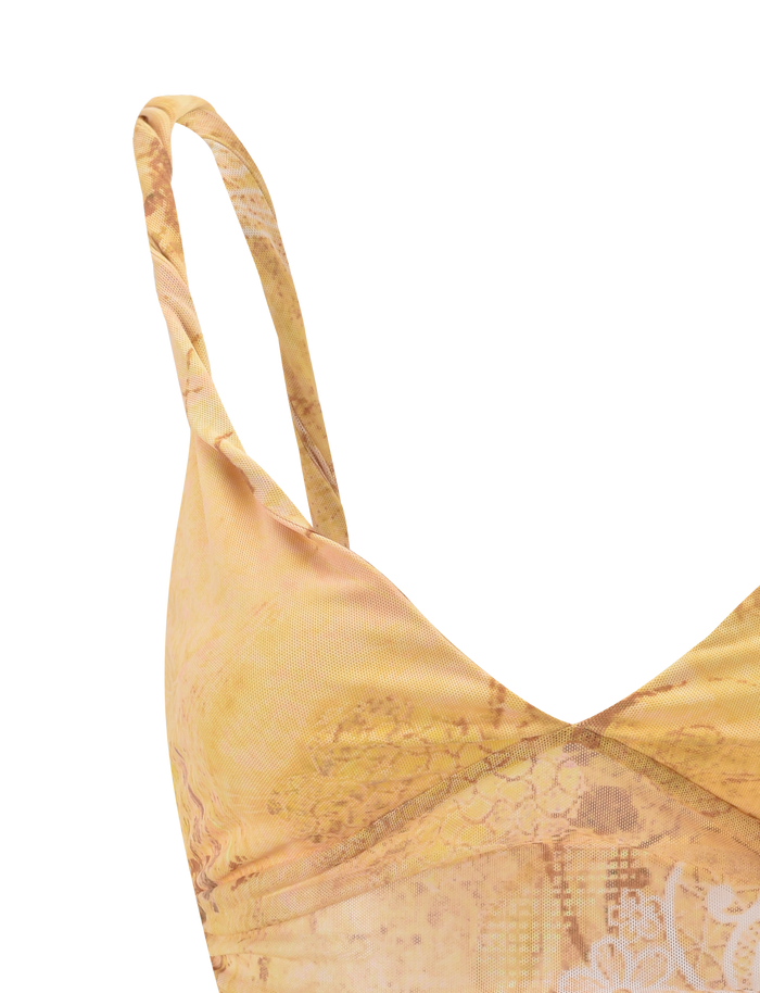 Close-up of the TIGERMIST THEO TOP in Lemon Butterfly Paisley, showing thin straps, subtle lace and floral details, and adjustable back ties. Only the upper left part is visible against a light background.