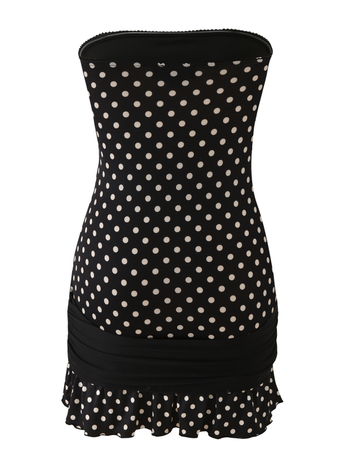 The TIGERMIST TOVE MINI DRESS - BLACK POLKA DOT is a strapless bodycon mini dress featuring a ruched black band and playful ruffle hem with a white polka dot trim.