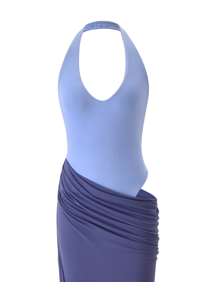 The TIGERMIST TYANA MAXI DRESS - CORNFLOWER is a halter neck maxi featuring a light blue fitted bodice with plunging neckline and deep blue, draped ruched skirt, shown on a white background.