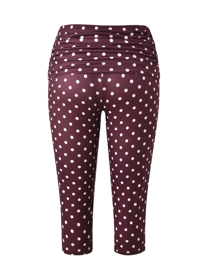 The TIGERMIST VALI POLKA DOT CAPRI in chocolate with pink dots features a high, ruched waistband and is shown from the back against a white background.
