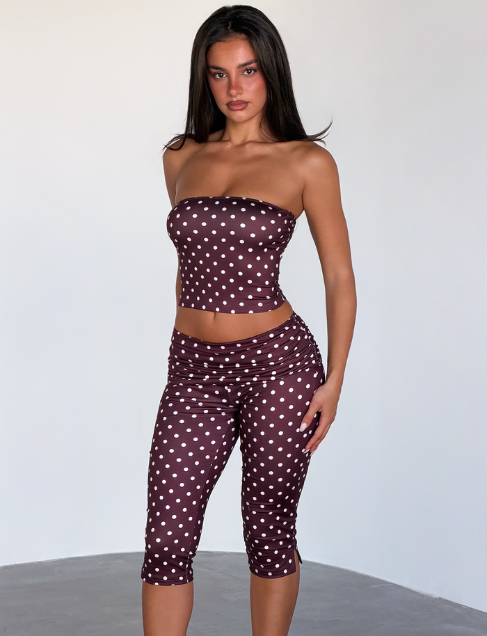 A woman models the TIGERMIST VALI POLKA DOT TOP in chocolate pink dot, posing indoors against a plain white background and looking directly at the camera.