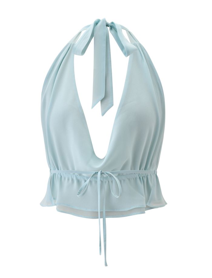 The TIGERMIST VEDA OPEN BACK COWL TOP in seafoam features an adjustable halter neck, deep V-neck, tie closures at the neck and waist, and a ruffled hem, shown on a white background.