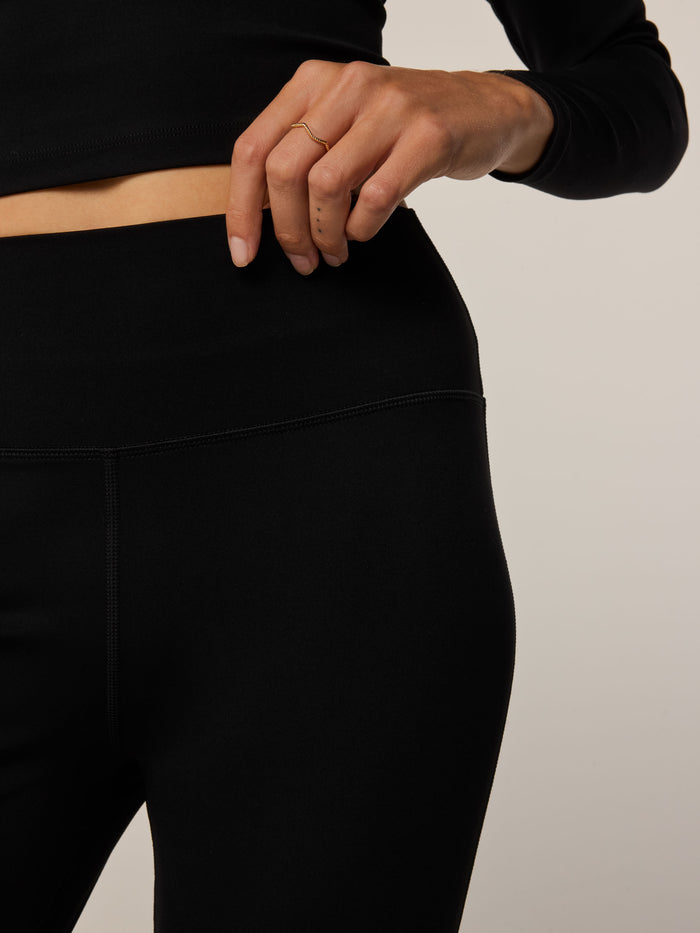 Greyson Clothiers Venus Flare Pant in Black - Close-Up, High-Rise Waistband Seam Detail On Model | Greyson Clothiers