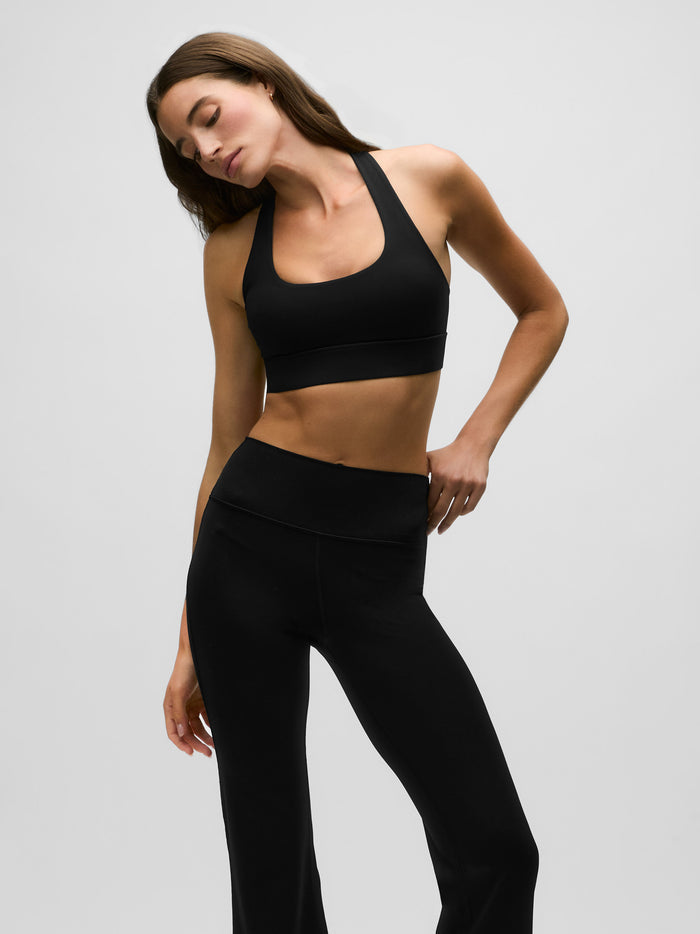 Black Stretch Venus Sports Bra Scoop Neck Racerback - Front Angle On Model | Greyson Clothiers