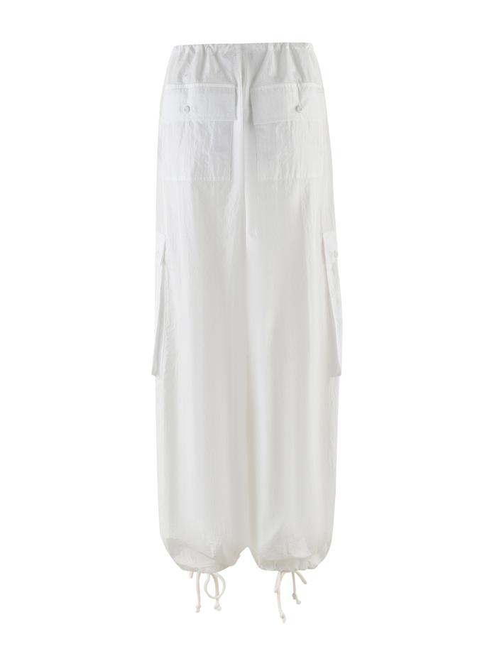 The TIGERMIST VIOLETTE PANT in white features a baggy ankle-length fit, elastic waistband, front patch and side cargo pockets, plus adjustable drawstring hems, shown on a plain white background.