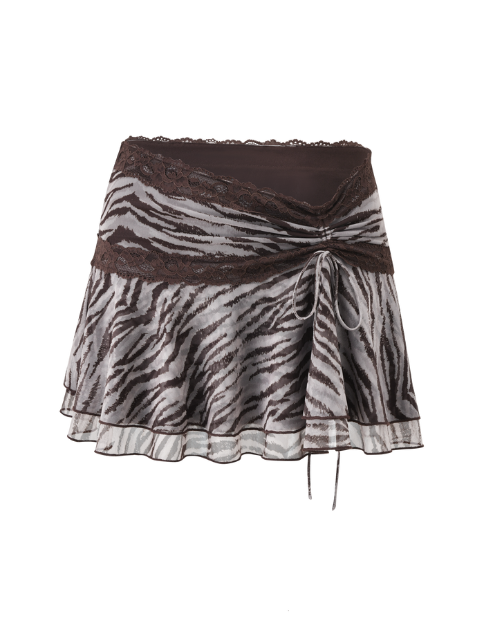 The TIGERMIST VIRA MINI SKIRT in Neutral Zebra features double tiered ruffles, a brown lace trimmed waistband, and a side tie. This lightweight, slightly sheer mesh mini skirt adds a bold, playful touch to your look.