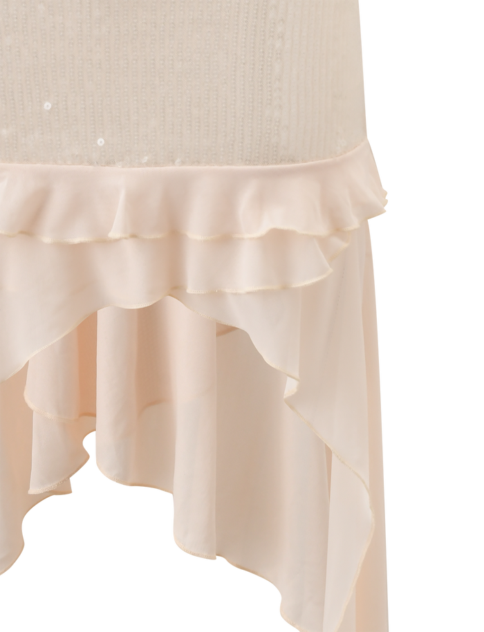 Close-up of the TIGERMIST WILLAH DRESS in cream, featuring a knit bodice, adjustable spaghetti straps, and an asymmetrical layered ruffled chiffon hem. Lightweight and delicate fabric.