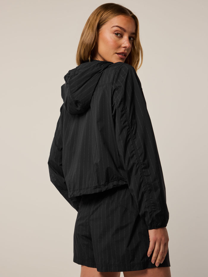 Wind Pinstripe Jacket in black - Back View, hooded women's pinstripe windbreaker with drawcord hem | Greyson Clothiers