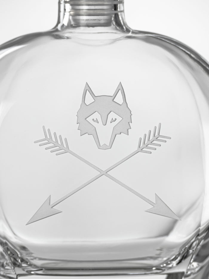 Wolf and Arrows Etched Logo Close-Up on Clear Glass Decanter | Greyson Clothiers