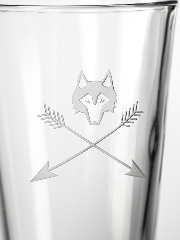 Greyson Clothiers Wolf and Arrows Pint Glass - Engraved Wolf Logo and Crossed Arrows Close-Up Detail | Greyson Clothiers