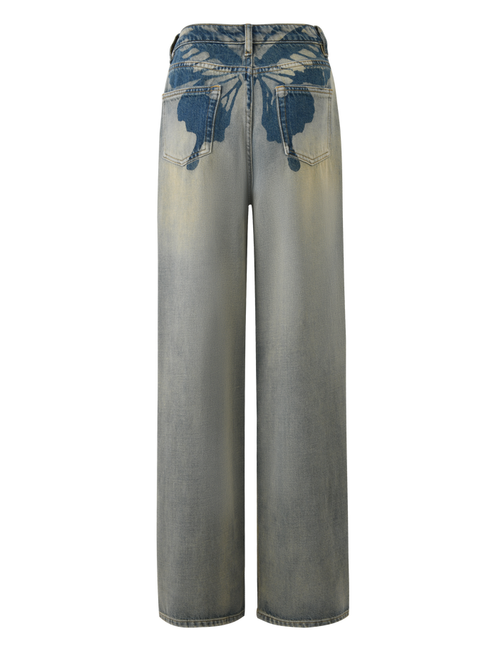 The TIGERMIST ZANTHE JEAN in grey wash features an oversized wide-leg fit and is shown from the back, highlighting two large indigo blue angel wing designs above the rear pockets on rigid denim.