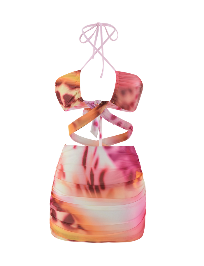 The TIGERMIST ZARIAH MINI DRESS - MACRO ORCHID is a sleeveless, fitted bodycon mini with pink, orange, and white abstract tie-dye, cut-out sides, crisscross halter neck straps, and adjustable bust panels.
