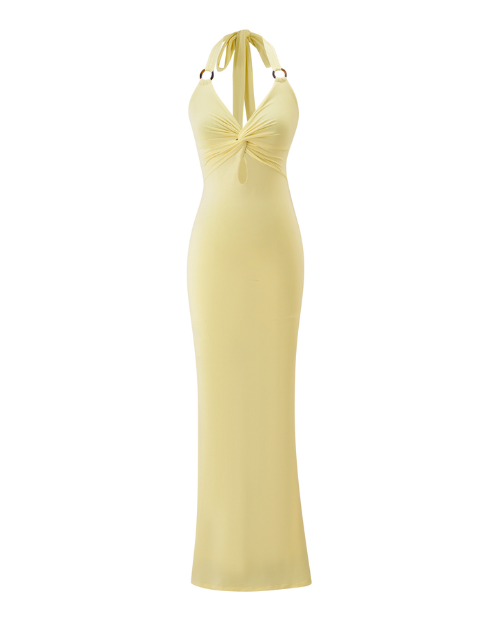 The ZENEVA MAXI DRESS in Lemon by TIGERMIST is a long yellow halter dress in buttery jersey with a knotted front, open back, slim silhouette, and tortoise shell ring details at the straps.