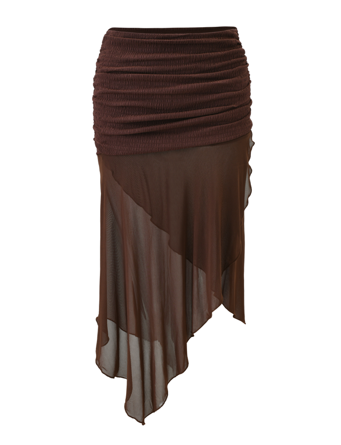 The ZINNIA MIDI SKIRT - CHOCOLATE by TIGERMIST is a chocolate brown midi skirt with a textured stretch knit waistband, lightweight flowy fabric, and a sheer asymmetrical hem with layered detailing at the top.