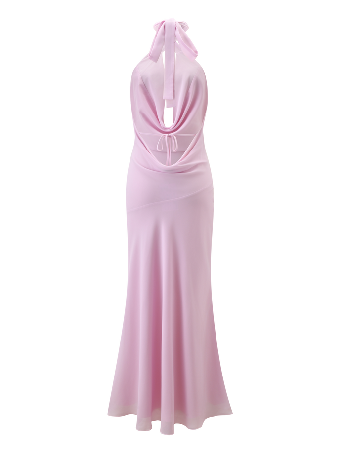 Back view of the ZYLA MAXI DRESS by TIGERMIST in baby pink, featuring a halter neck, open cowl back tied at the neck and lower back, and a flowing chiffon floor-length skirt.